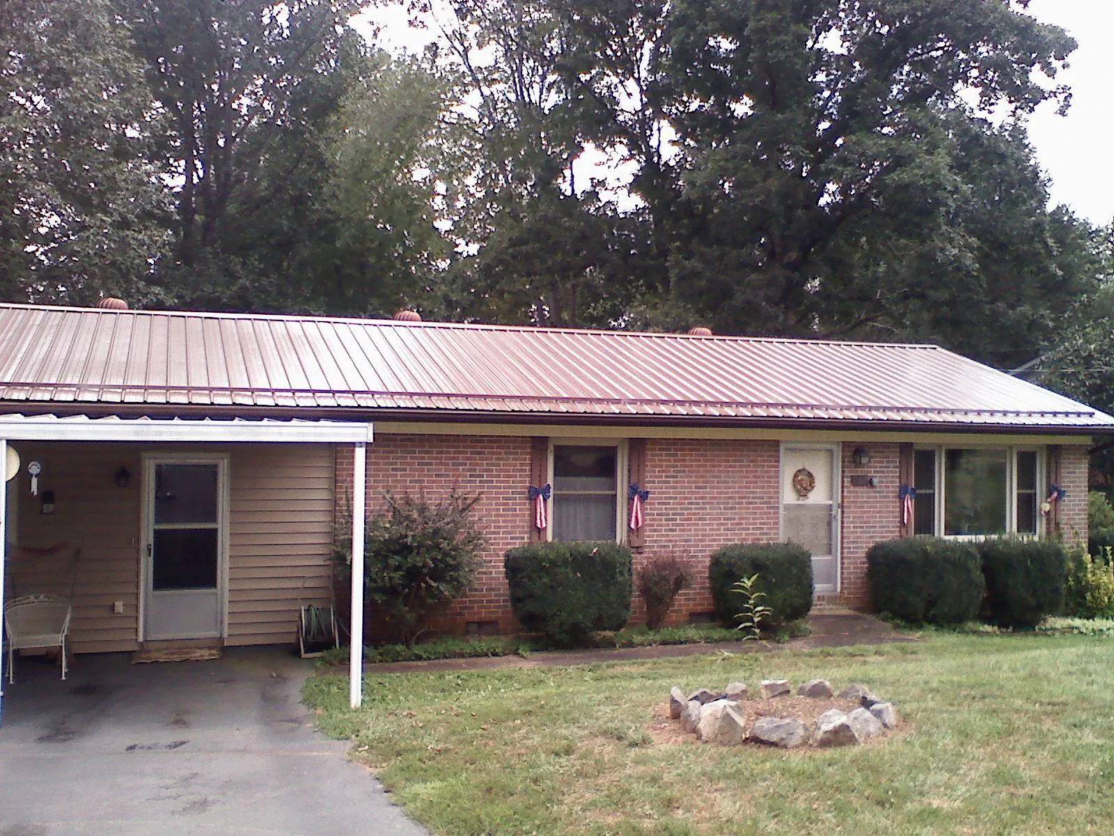 Bronze metal roof and carport on a brick ranch home — Roof Repair work by our crew in Brookdale