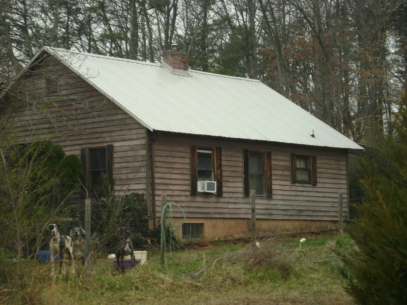 White metal roof on an old wood sided farmhouse, from a Metal Roof Installation job in Brookdale